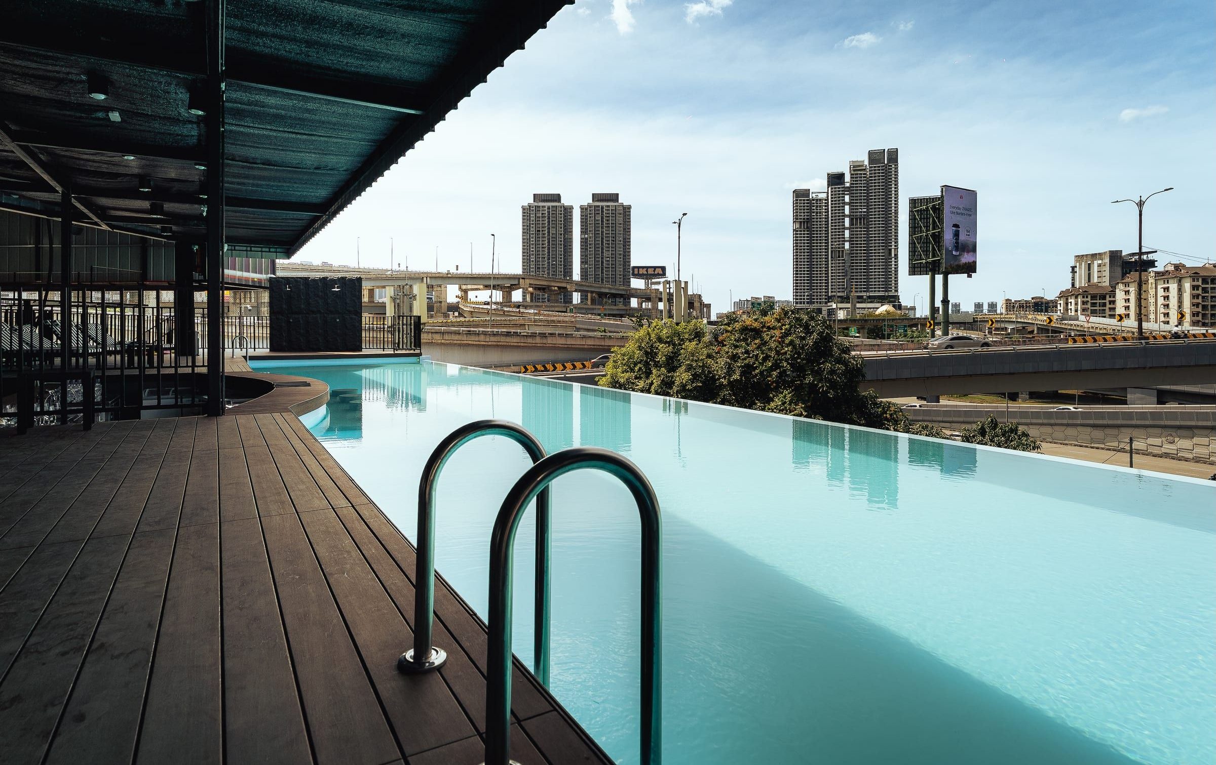 Rooftop infinity pool with city towers beyond
