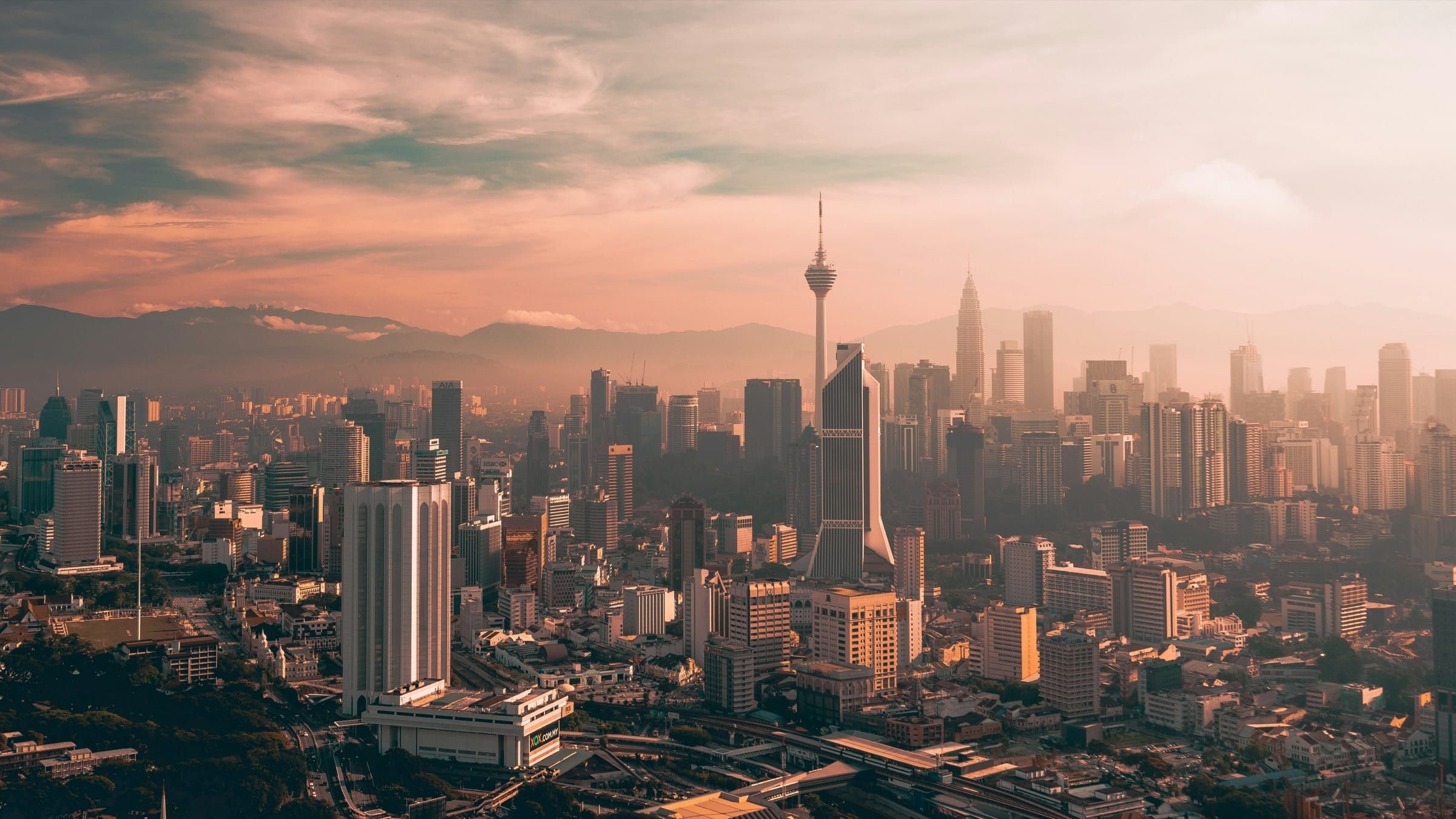 Kuala Lumpur skyline at sunset, with KL Tower rising above the city