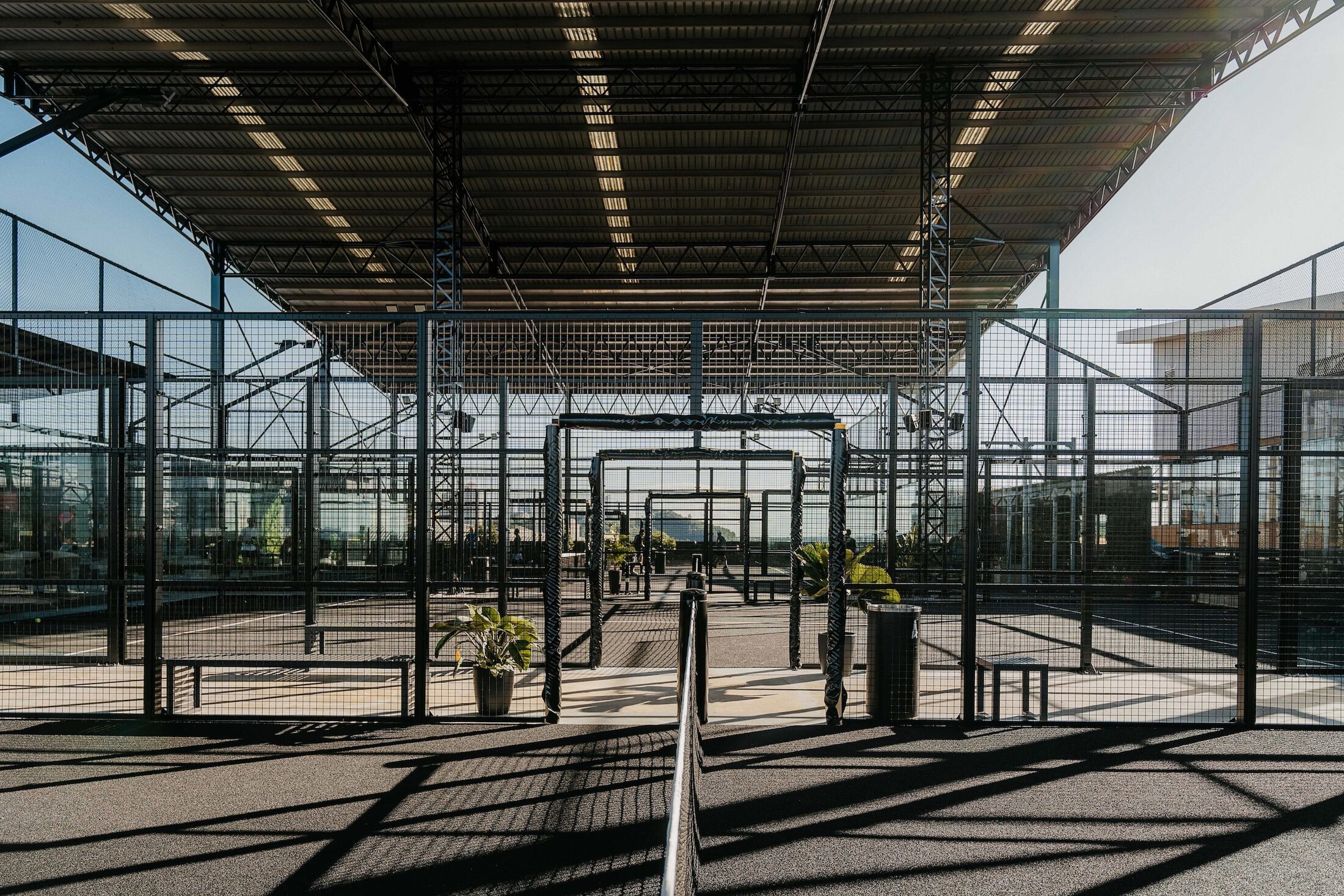 Covered padel courts under a steel roof